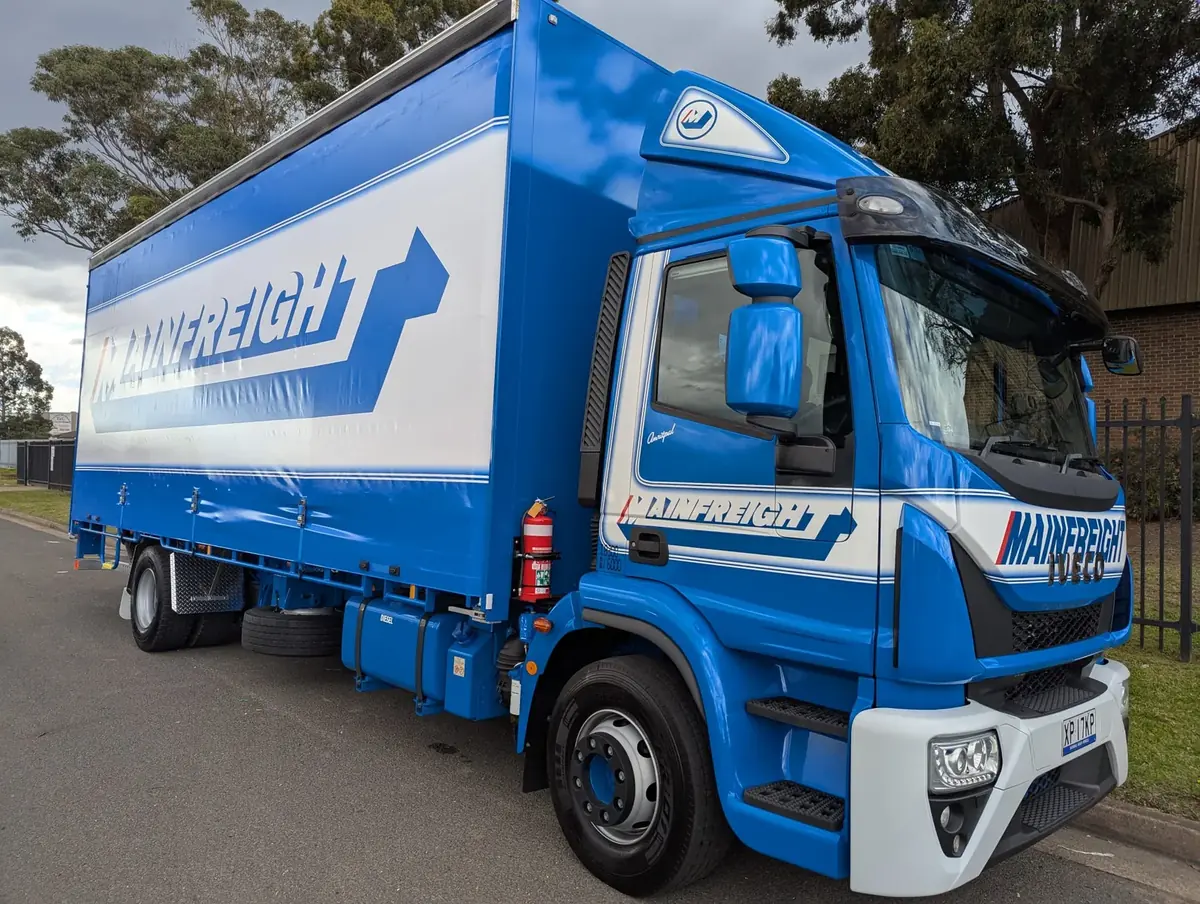 Rigid curtainsider truck finished in a blue and white fleet livery