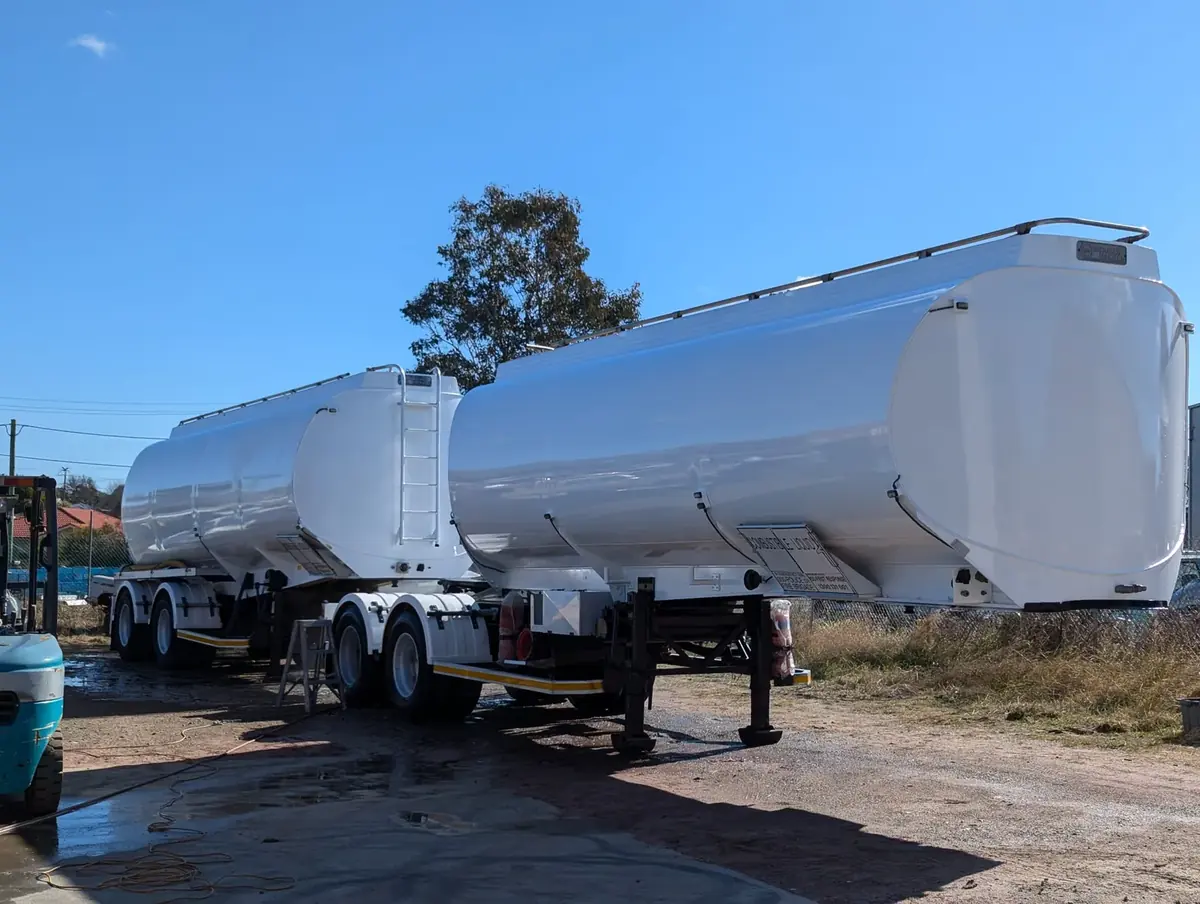 Pair of tanker trailers with the tanks painted white
